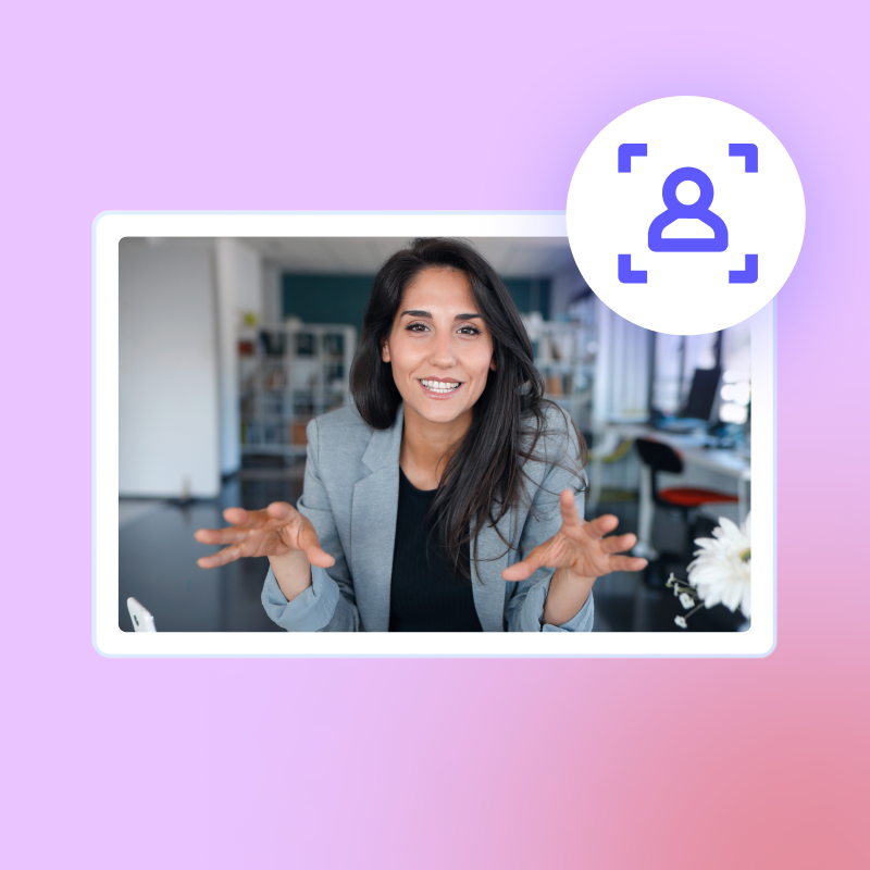 A woman in a business suit gestures with open hands, smiling warmly at the camera in a modern office setting, showcasing a presentation created with Biteable video maker.